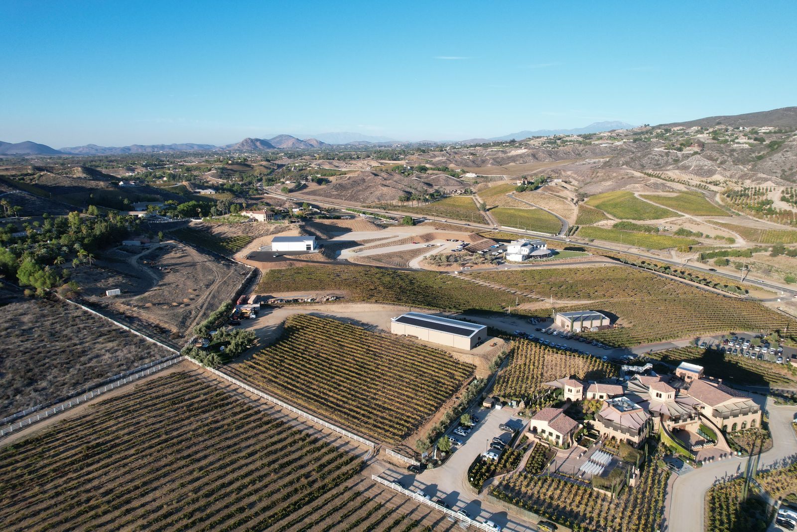 Aerial view of vineyards and winery buildings in the hills of the Temecula Valley